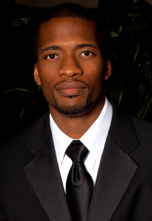 A person wearing a suit and tie

Description automatically generated